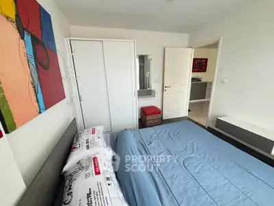 Modern bedroom with stylish decor and ample storage in a contemporary apartment.