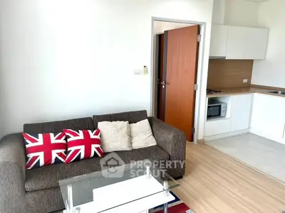 Modern living room with stylish sofa and open kitchen layout