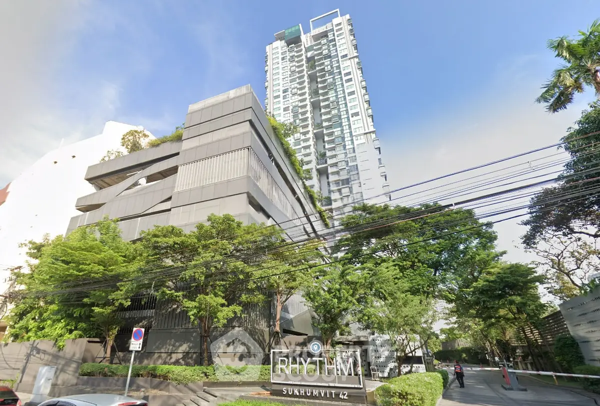 Modern high-rise condominium with lush greenery at Rhythm Sukhumvit 42, offering urban living in Bangkok.