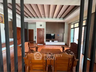Spacious living room with elegant wooden furniture and modern entertainment center