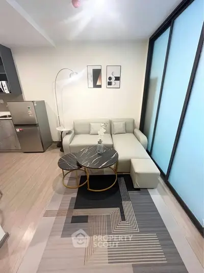 Modern living room with stylish decor and natural light, featuring a cozy sofa and elegant coffee tables.