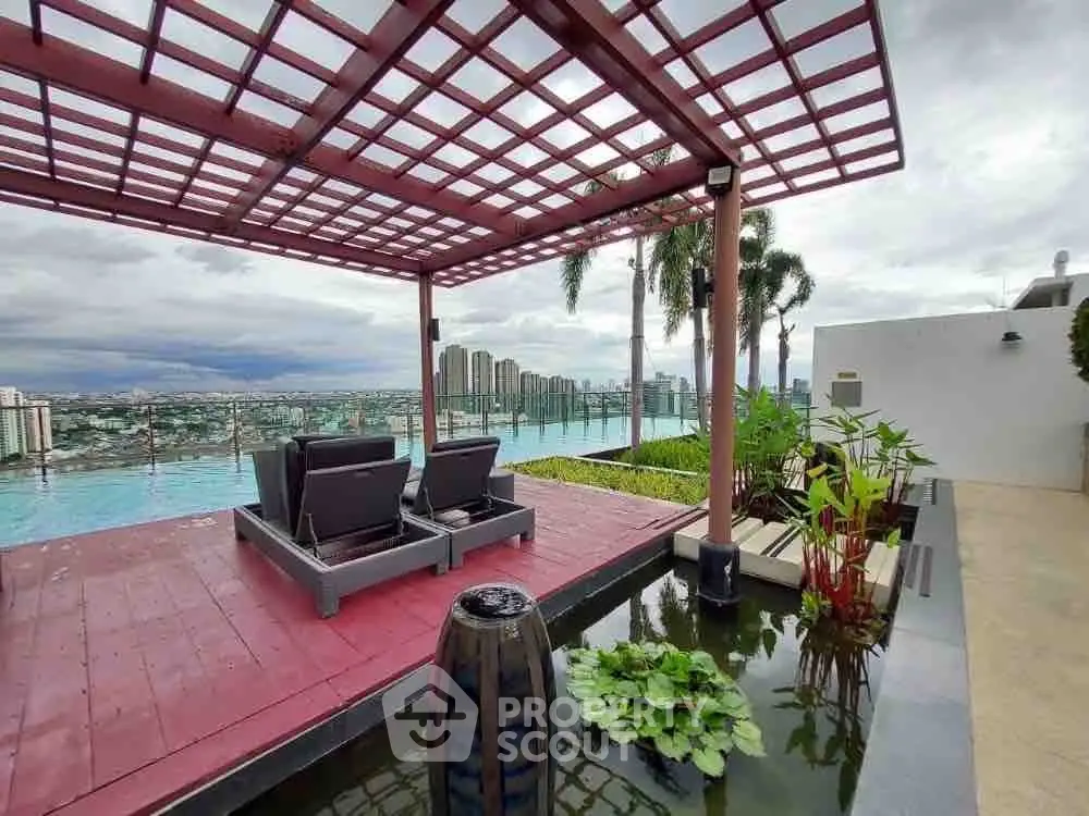 Luxurious rooftop pool with stunning city view and modern lounge area.