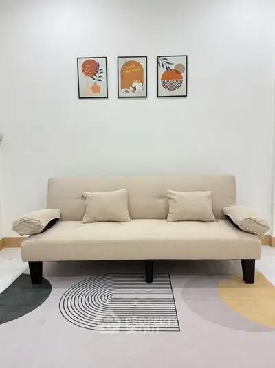 Modern living room with stylish beige sofa and abstract wall art