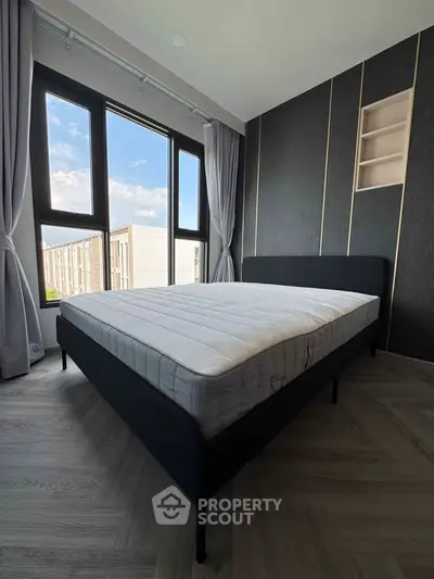 Modern bedroom with large windows and stylish decor