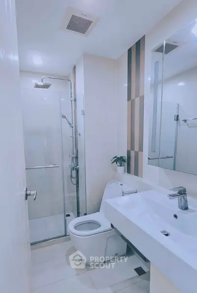 Modern bathroom with glass shower and sleek fixtures