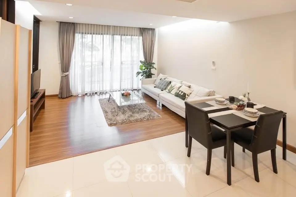 Spacious modern living room with elegant dining area and large windows.