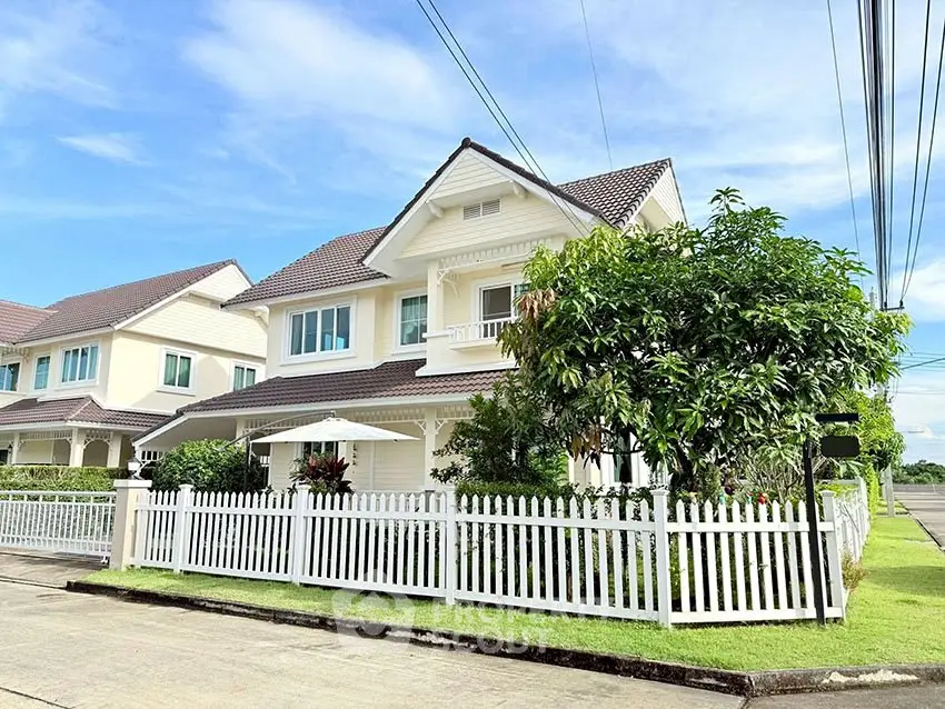 Charming suburban house with white picket fence and lush garden, perfect for family living.