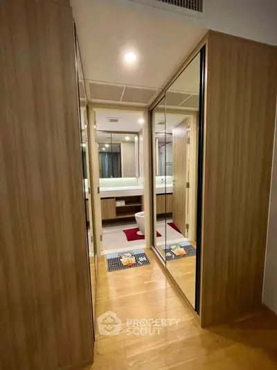 Modern bathroom with wooden accents and mirrored closet doors