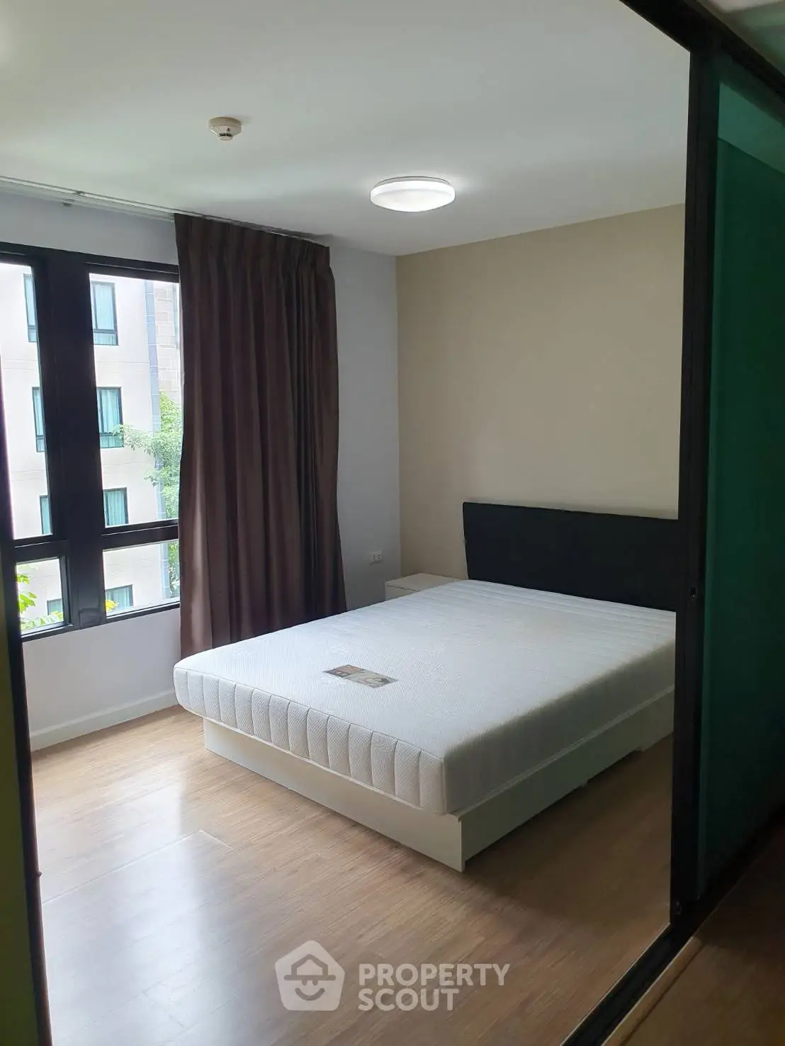 Modern bedroom with large window and minimalist decor