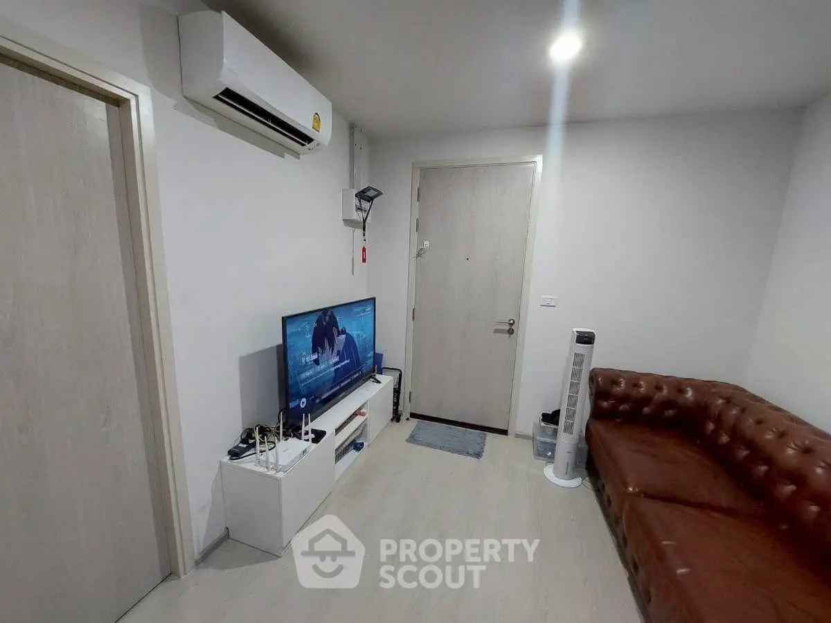 Cozy living room with leather sofa and modern entertainment setup