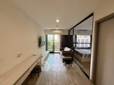 Modern studio apartment with open layout and balcony view