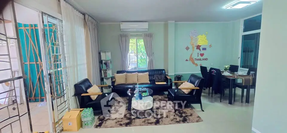 Spacious living room with modern furniture and natural light in a cozy home setting.
