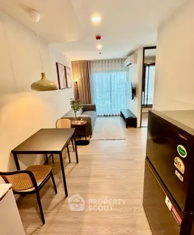 Modern living room with dining area and stylish decor in a cozy apartment.