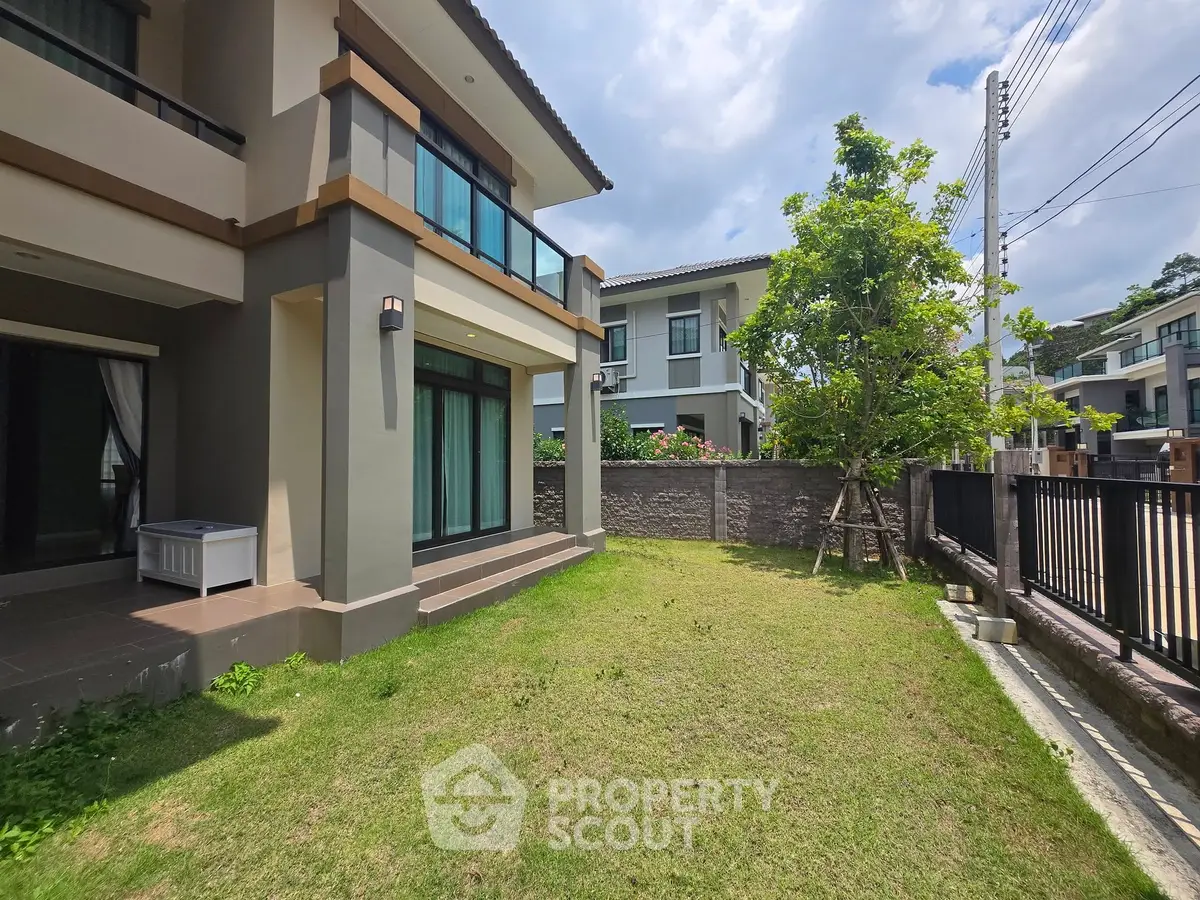 Modern two-story house with spacious garden and contemporary design in a serene neighborhood.