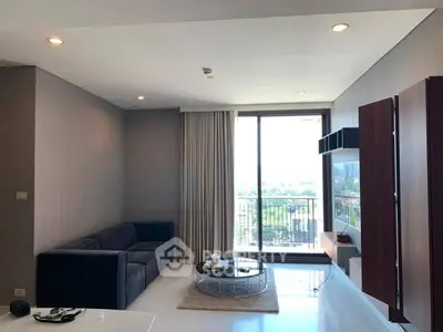 Modern living room with large window and stylish furniture