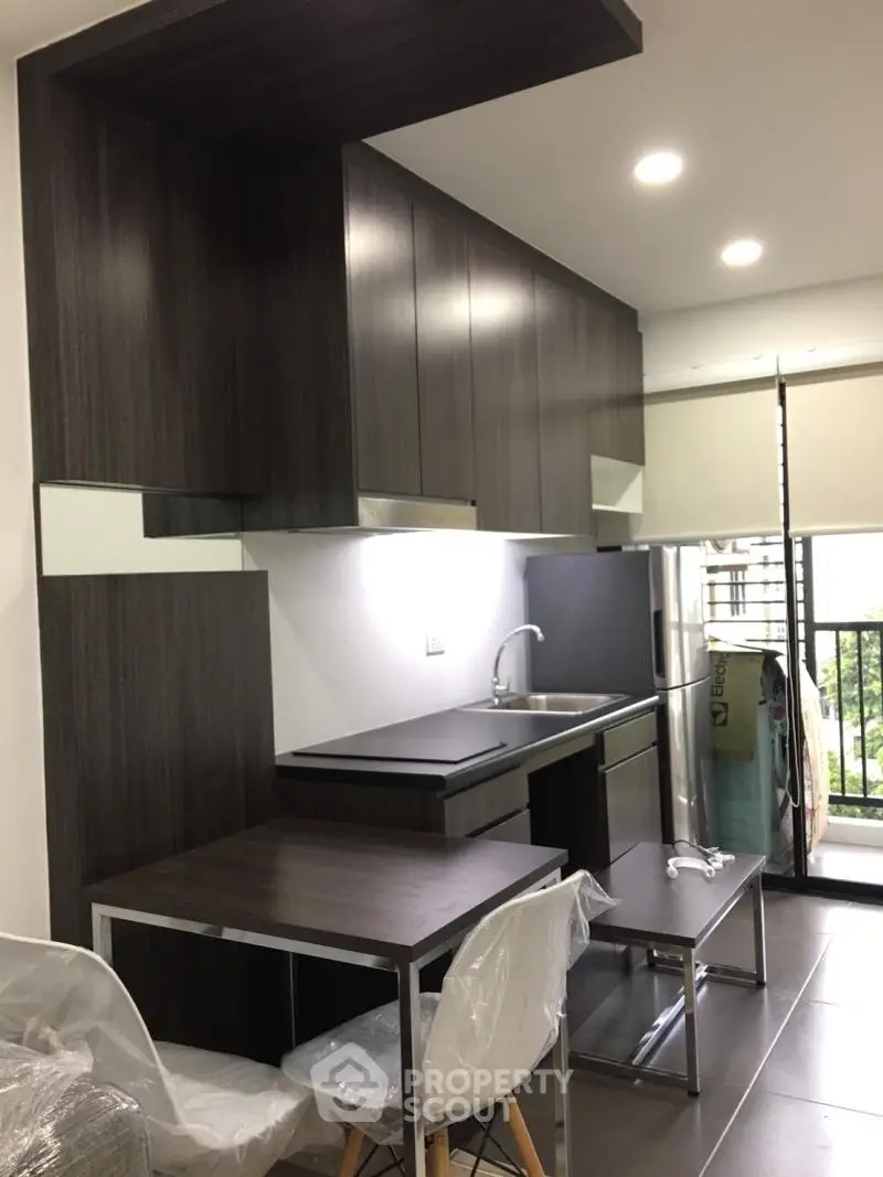 Modern kitchen with sleek dark cabinetry and open layout design