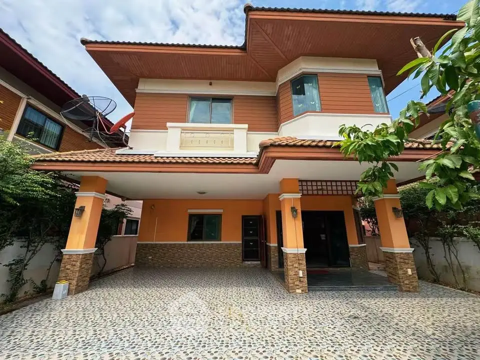 Stunning two-story house with unique architectural design and spacious driveway, perfect for family living.