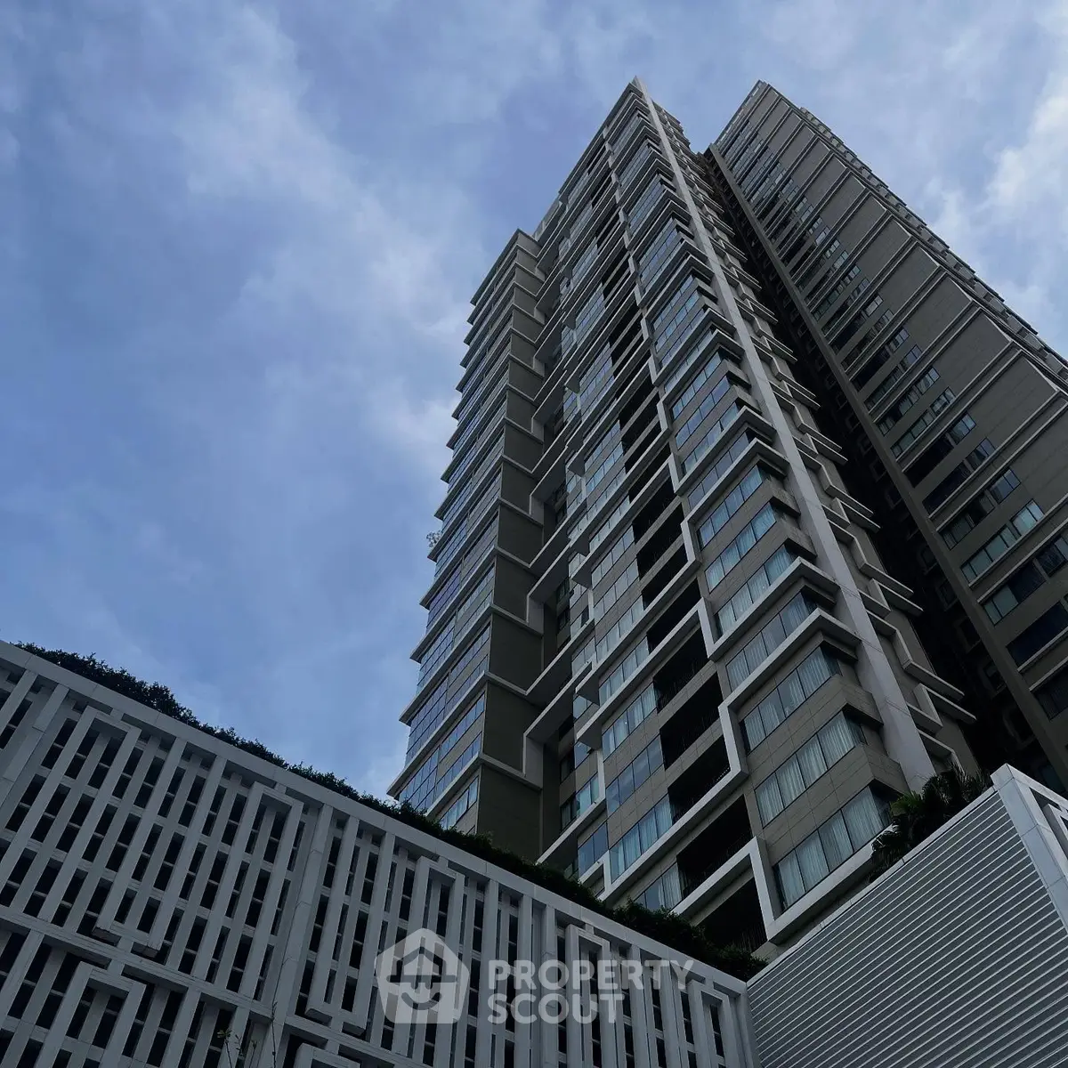 Stunning modern high-rise building with unique architectural design against a clear blue sky.