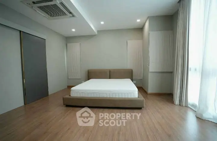 Spacious modern bedroom with minimalist design and natural light