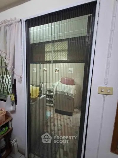 Cozy laundry area with washing machine and storage space, perfect for efficient home organization.