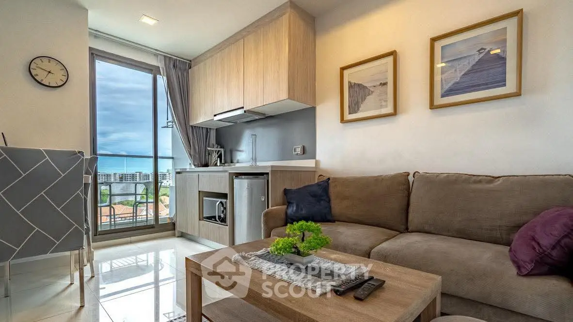 Modern living room with cozy sofa and stylish kitchen in open layout apartment.