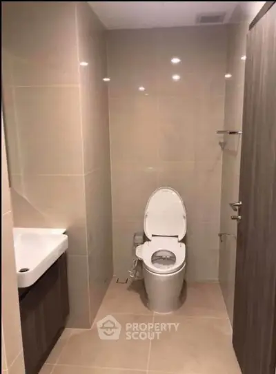 Modern bathroom with sleek fixtures and neutral tiles, perfect for a contemporary home.