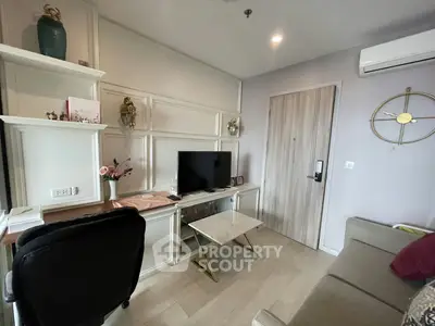 Modern living room with stylish decor and wall-mounted TV, featuring elegant shelving and cozy seating.