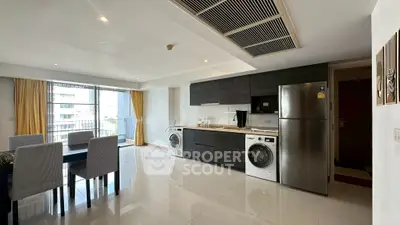Spacious modern kitchen and dining area with sleek appliances and large windows.