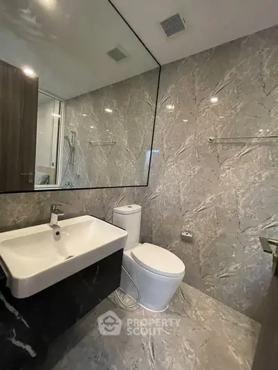 Luxurious modern bathroom with marble walls and sleek fixtures