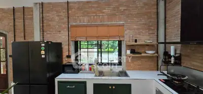 Charming rustic kitchen with brick walls and modern appliances, featuring a large window with a scenic view.