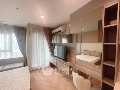 Modern bedroom with stylish decor and large windows offering natural light.