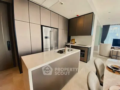 Luxurious modern kitchen with sleek cabinetry and island in open layout apartment