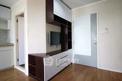 Modern apartment interior with sleek TV unit and wooden flooring