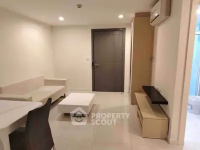 Modern living room with sleek furniture and air conditioning in a stylish apartment.