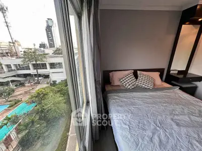 Cozy bedroom with city view and poolside scenery, perfect for urban living.