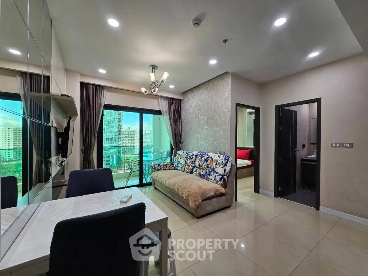 Modern living room with city view, stylish decor, and open layout in a high-rise apartment.