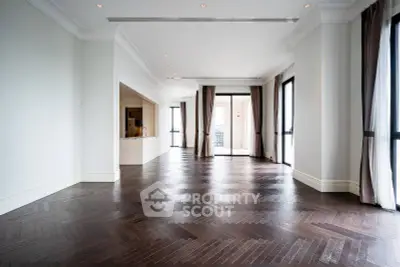 Spacious luxury living room with elegant hardwood floors and large windows