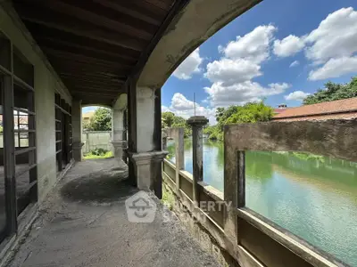 Charming riverside balcony with rustic architecture and scenic water views.