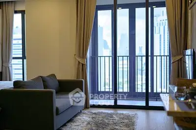 Modern living room with city view, cozy sofa, and elegant decor in a high-rise apartment.