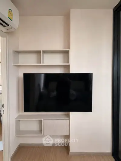 Modern living room with wall-mounted TV and sleek storage shelves