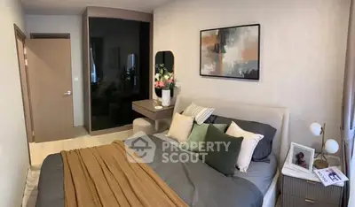 Cozy modern bedroom with stylish decor and comfortable bedding in a contemporary apartment.