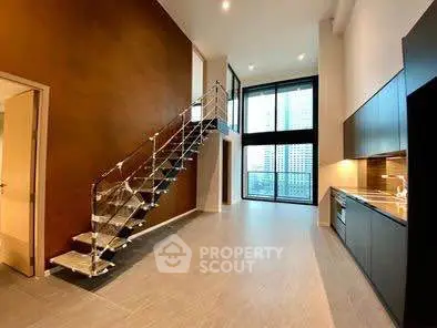 Modern loft apartment with sleek staircase and open kitchen layout, featuring floor-to-ceiling windows.