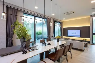 Modern living room with elegant dining area, large windows, and stylish decor in a luxurious apartment.