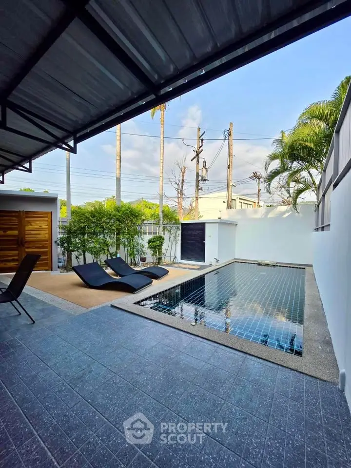 Luxurious private pool area with modern design and lush greenery, perfect for relaxation and entertainment.