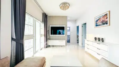 Spacious modern living room with elegant decor and large windows for natural light.