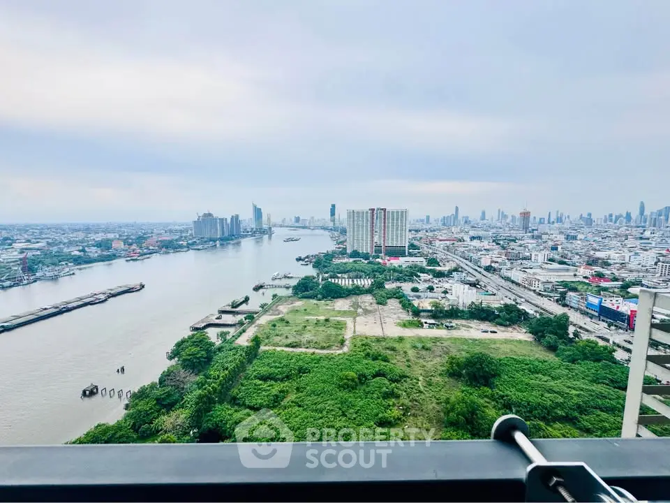 Stunning cityscape view from high-rise balcony overlooking river and skyline, perfect for urban living.