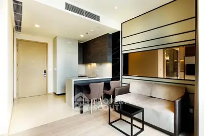 Modern open-layout living room with sleek kitchen and stylish furniture in a contemporary apartment.