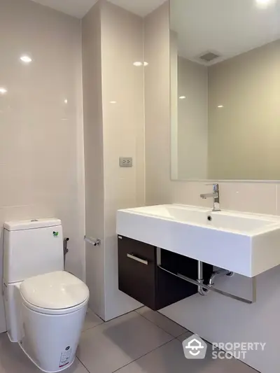 Modern bathroom with sleek fixtures and large mirror