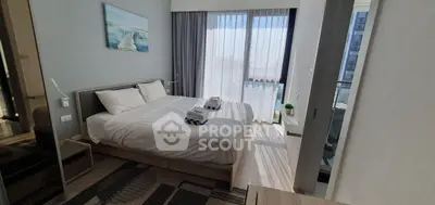 Bright and modern bedroom with balcony access in a stylish apartment.