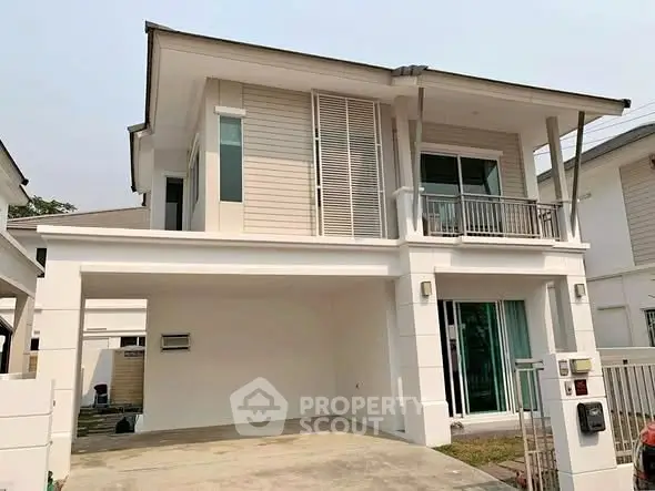 Modern two-story house with balcony and spacious driveway